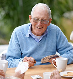 A group of senior citizens playing cards together.